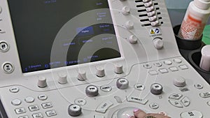 Hand of woman and ultrasound examination medical equipment.