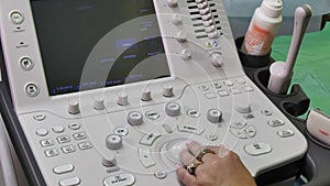 Hand of woman and ultrasound examination medical equipment.