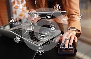 Hand woman use calculator doing calculate finance and tablet on desk about cost at office