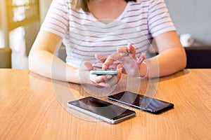 Hand woman using mobile phone,social media,relaxed girl checking cell phone at canteen