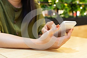Hand of woman using smart phone. Online shopping mobile payment and e-commerce concept