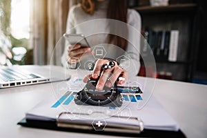 Hand women doing finances and calculate on desk in the morning.