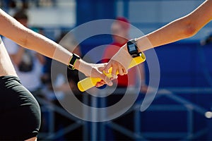 hand women passing baton running relay race