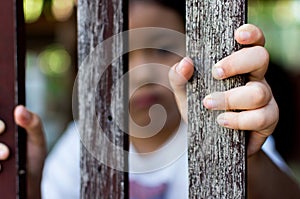 Hand with wood fence, feeling no freedom.