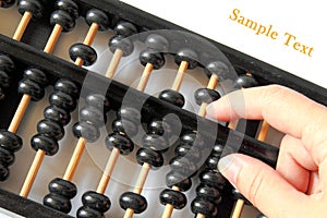 Hand and a wooden abacus with copy space