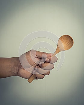 Hand with woodenspoon.