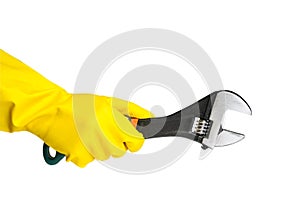 Hand in work glove holding adjustable wrench