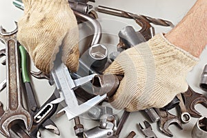 Hand of worker measure the part with calliper in the workshop