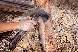 Hand working with axe