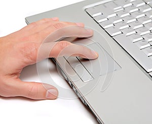 Hand working on a laptop touchpad