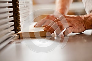 Hand working with a wood shaper