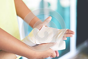 Hand wound bandaging arm by nurse - first aid wrist injury health care and medicine concept