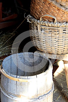 Hand woven baskets and barrels in barn doorway