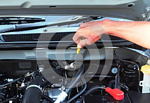 Hand with wrench checking car engine.