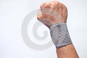 hand with wrist support against blue background.