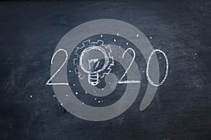 Hand write 2020 with light idea on blackboard