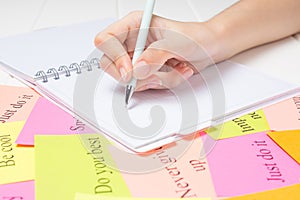 The hand writes on a white page in the daily planner.Student, study, synopsis. Affirmations, visualization, to-do lists. Plan,