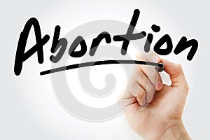 Hand writing Abortion with marker