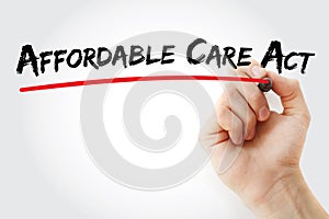 Hand writing Affordable Care Act with marker, health concept background
