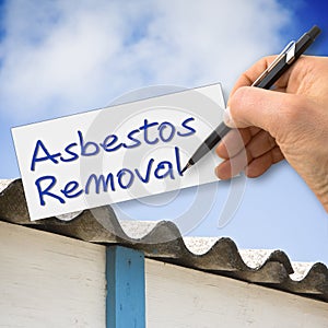 Hand writing Asbestos Removal with a pencil on a sheet photo