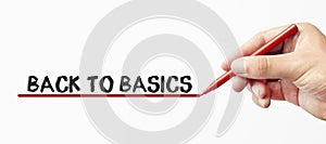 Hand writing BACK TO BASICS with red marker. Isolated on white background. Business, technology, internet concept. Stock Image