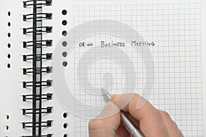 Hand writing business meeting details