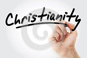 Hand writing Christianity with marker