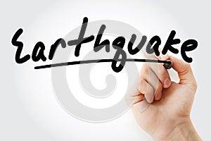 Hand writing Earthquake with marker