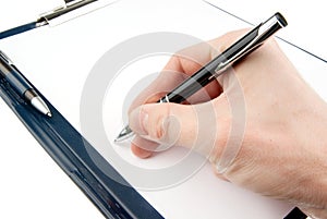 Hand writing on an empty document in a clipboard