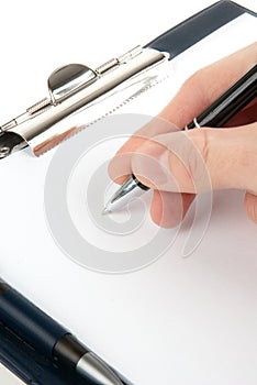 Hand writing on an empty document in a clipboard