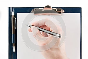 Hand writing on an empty document in a clipboard