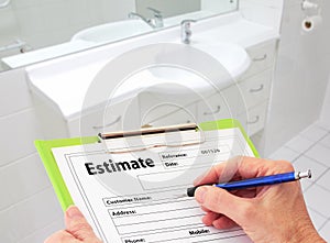 Hand Writing an Estimate for Bathroom Renovation