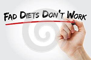 Hand writing Fad Diets Don`t Work with marker, health concept background