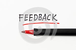 Hand writing Feedback with black and red marker on white paper