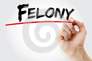 Hand writing Felony with marker