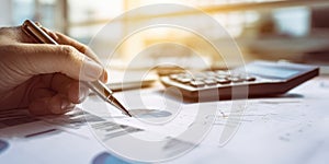 The hand writing on financial documents with a calculator in the background. AI generated image