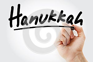 Hand writing Hanukkah with marker