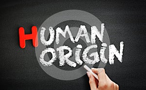 Hand writing Human origin on blackboard, concept background