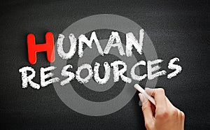 Hand writing Human Resources on blackboard, concept background