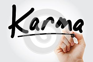 Hand writing Karma with marker