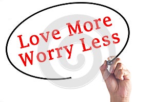 Hand writing Love More Worry Less on transparent board