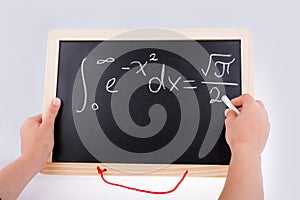 Hand writing a math problem on board