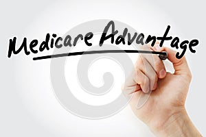 Hand writing Medicare Advantage with marker photo