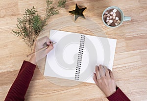 Hand writing mockup postcard for to do list and hot chocolate with marshmallow on wooden background. winter Christmas and Happy