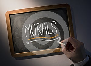 Hand writing Morals on chalkboard