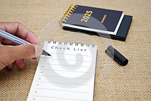 Hand writing in notebook new year resolutions and goals 2025