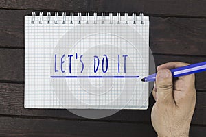 Hand writing on notepad: Let`s do it