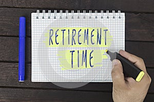 Hand writing on notepad: retirement time