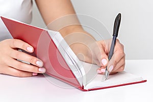 Hand writing notes to notebook