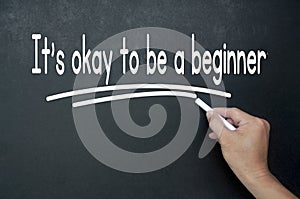 Hand writing It is okay to be a beginner affirmation on black board. Affirmation concept